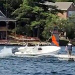 In a still frame from video provided by Rich Bono, an empty runaway boat speeds in circles, Wednesday, July 3, 2024, on Lake Winnipesaukee's Smith Cove, off Gilford, N.H. The empty runaway boat was brought safely to a stop by a teenager who jumped aboard from a personal watercraft.