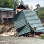 Trees and debris sit next to a damaged home after flooding in Lyndonville, Vt., Tuesday, July 30, 2024.