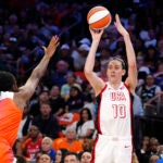 Breanna Stewart (10), of Team USA, looks to shoot a 3-point basket over Aliyah Boston, of Team WNBA, during the first half of a WNBA All-Star basketball game.