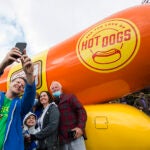 People pose in front of the Oscar-Mayer Wienermobile.