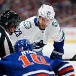 EDMONTON, CANADA - MAY 18: Elias Lindholm #23 of the Vancouver Canucks faces off against Derek Ryan #10 of the Edmonton Oilers during the first period of Game Six in the Second Round of the 2024 Stanley Cup Playoffs at Rogers Place on May 18, 2024 in Edmonton, Canada.