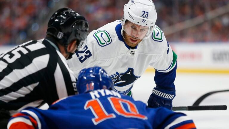 EDMONTON, CANADA - MAY 18: Elias Lindholm #23 of the Vancouver Canucks faces off against Derek Ryan #10 of the Edmonton Oilers during the first period of Game Six in the Second Round of the 2024 Stanley Cup Playoffs at Rogers Place on May 18, 2024 in Edmonton, Canada.