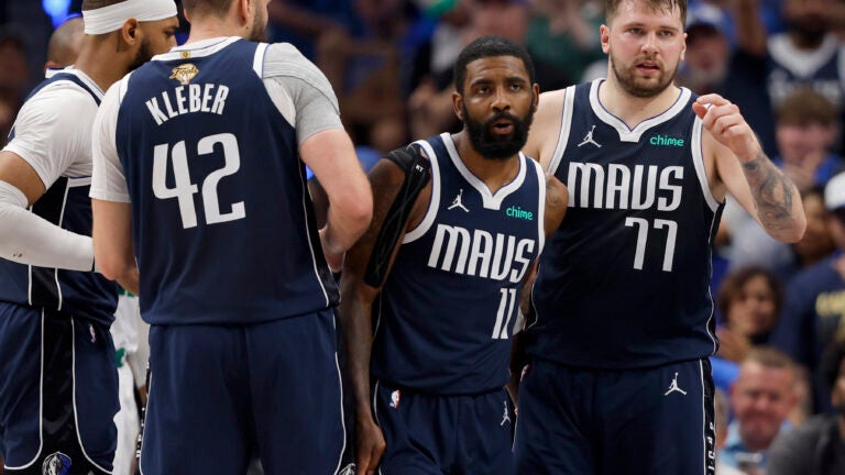 Dallas Mavericks guard Kyrie Irving (11) and Dallas Mavericks guard Luka Doncic (77) look on during the second quarter in Game 4 of the NBA Finals.