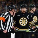 BOSTON, MASSACHUSETTS - MAY 17: Brad Marchand #63 of the Boston Bruins listens to referee Kelly Sutherland #11 during a game against the Florida Panthers during the second period in Game Six of the Second Round of the 2024 Stanley Cup Playoffs at the TD Garden on May 17, 2024 in Boston, Massachusetts.