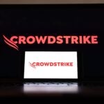 the CrowdStrike logo is displayed on a cell phone and computer monitor on July 19, 2024 in Los Angeles, California.