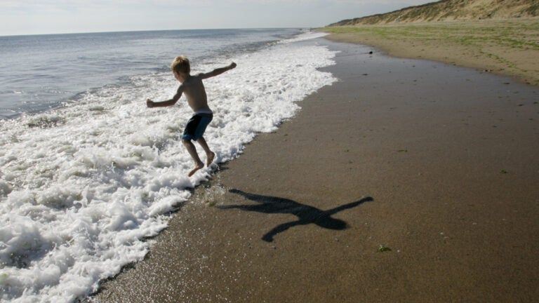 A boy jumps over a wave at Marconi Beach at the Cape Cod National Seashore.