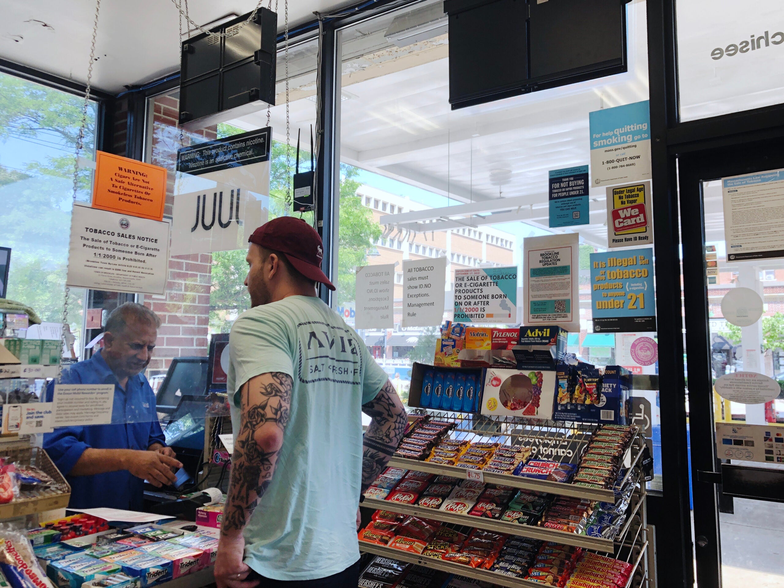 At a convenience store in Brookline, Mass., signs explain the town's pioneering bylaw on tobacco and nicotine sales.