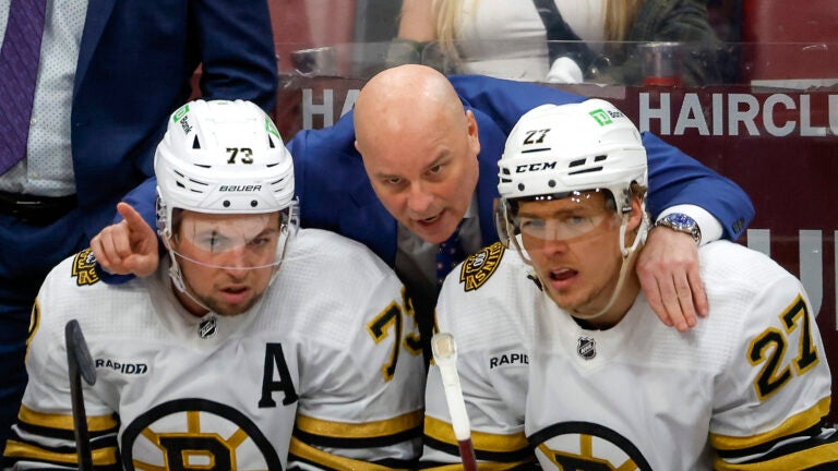 Boston Bruins head coach Jim Montgomery talking to defenseman Charlie McAvoy (73) and defenseman Hampus Lindholm (27) moments after Florida Panthers scored the first goal of the game during second period in game one of the Eastern Conference NHL Playoffs at Amerant Bank Arena.