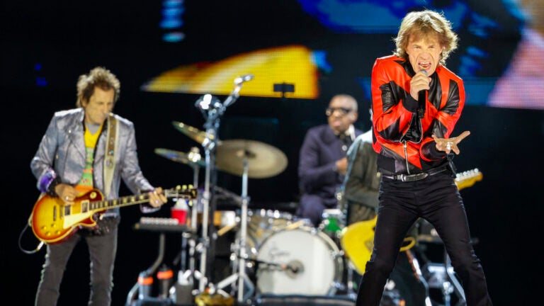 Mick Jagger lead singer for the Rolling Stones performs with his band at Gillette Stadium on May 30. In the background is Ron Wood and Steve Jordan.