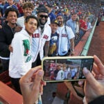 Before the game, Manny Ramirez, (right) who was selected for the Red Sox Hall of Fame last month, but who was not prersent at that ceremony was on hand to recieve his plaque tonight. He also threw out a ceremonial pitch to former teammate David Ortiz (center). After that they posed in the stands with their sons D'Angelo Ortiz (front row left) Manny Ramirez, Jr. (back row center) and Pedro Martinez, Jr. (back row left). The man between Ortiz and Ramirez is unidentified. Boston Red Sox hosted the Detroit Tigers in a regular season MLB baseball game at Fenway Park.