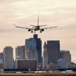 Seen from Winthrop, an American Airlines plane heads in for a landing at Boston Logan International Airport.