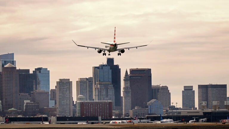 Seen from Winthrop, an American Airlines plane heads in for a landing at Boston Logan International Airport.
