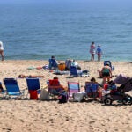 Summer Beach chairs are lined up on the Nauset Town Beach, Orleans on a hot summer day on Cape Cod.