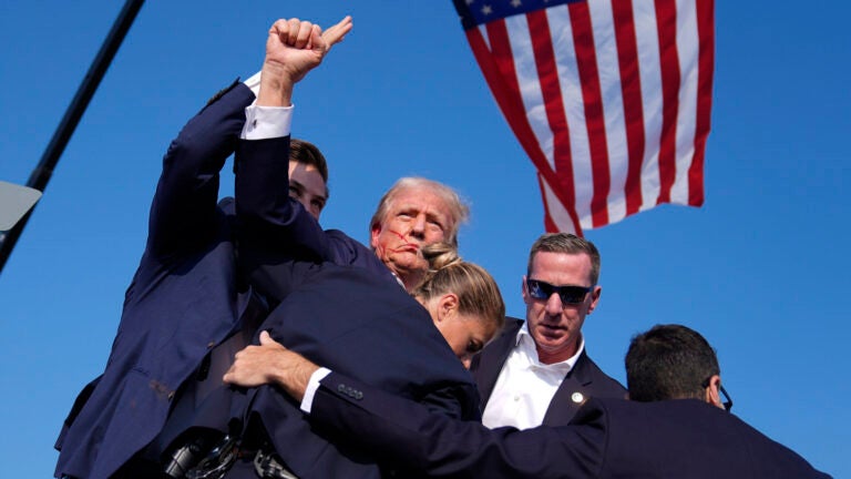 Republican presidential candidate former President Donald Trump is surrounded by U.S. Secret Service agents at a campaign rally, Saturday, July 13, 2024, in Butler, Pa.