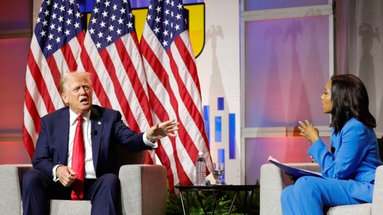 Former US President and 2024 Republican presidential nominee Donald Trump answers questions as moderator and journalist Rachel Scott (R) looks on during the National Association of Black Journalists annual convention in Chicago, Illinois, on July 31, 2024.