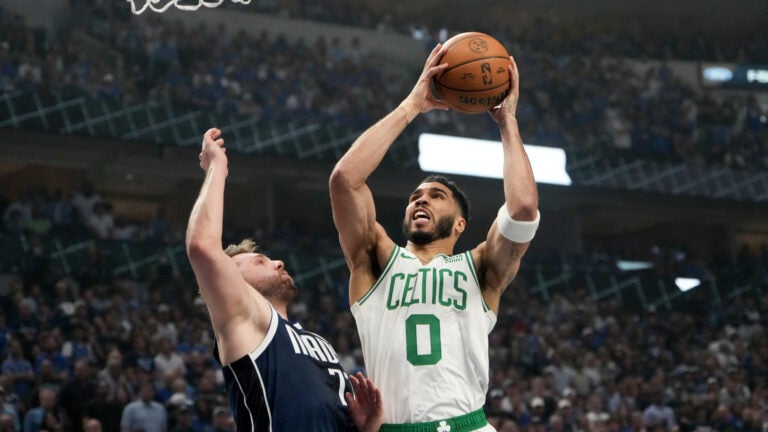Boston Celtics forward Jayson Tatum (0) drives against Dallas Mavericks guard Luka Doncic (77) during the first quarter in Game 3 of the NBA Finals. The Dallas Mavericks hosted the Boston Celtics at American Airlines Center on Wednesday, June 12, 2024.