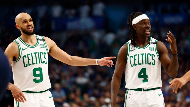 Boston Celtics guard Derrick White (9) and Boston Celtics guard Jrue Holiday (4) gesture towards the bench during the second quarter in Game 4 of the NBA Finals. The Dallas Mavericks hosted the Boston Celtics at American Airlines Center on Friday, June 14, 2024.