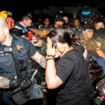 Officers of the Metropolitan Police Department pepper spray demonstrators at George Washington University in Washington.