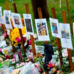 Rain-soaked memorials for those who died in a mass shooting sit along the roadside by Schemengees Bar & Grille, Oct. 30, 2023, in Lewiston, Maine.