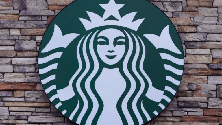 A Starbucks mermaid logo sign is displayed on a store.