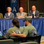 Members of the independent commission investigating the law enforcement response to the mass shooting in Lewiston, Maine, listen as Nicole Herling, below left, sister of shooter Robert Card, testifies.