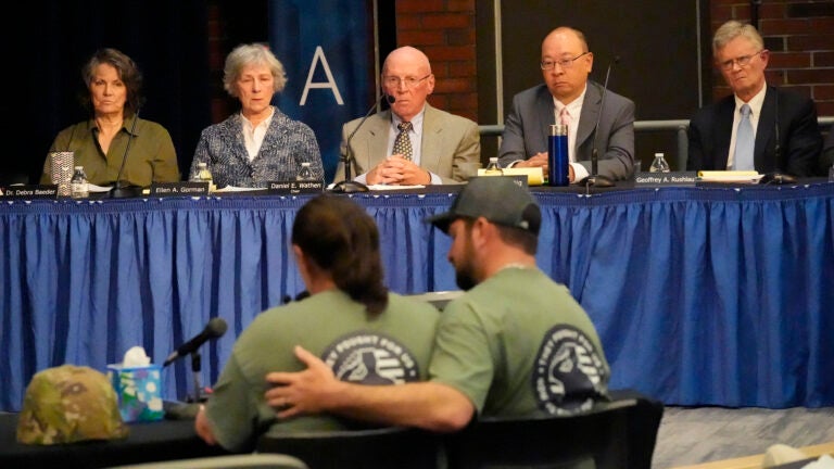 Members of the independent commission investigating the law enforcement response to the mass shooting in Lewiston, Maine, listen as Nicole Herling, below left, sister of shooter Robert Card, testifies.
