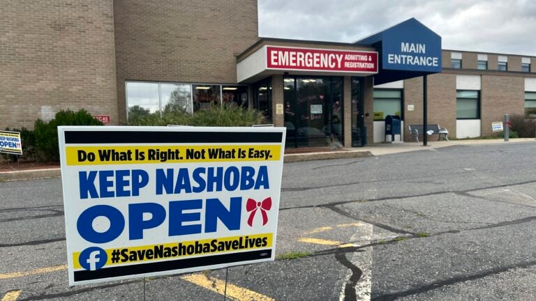 A sign pushing to keep the hospital open stands outside Nashoba Valley Medical Center in Ayer, Mass.