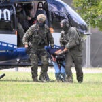 The alleged perpetrator of the knife attack in Solingen is escorted from a helicopter in Karlsruhe, Germany, Sunday, Aug. 25, 2024.