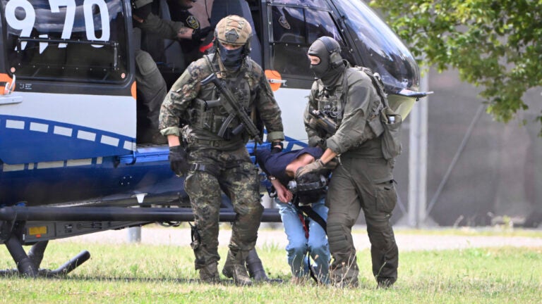 The alleged perpetrator of the knife attack in Solingen is escorted from a helicopter in Karlsruhe, Germany, Sunday, Aug. 25, 2024.