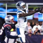 Carolina Panthers wide receiver Ihmir Smith-Marsette (11) grabs a pass against New England Patriots cornerback Shaun Wade, left, during the first half of a preseason NFL football game.