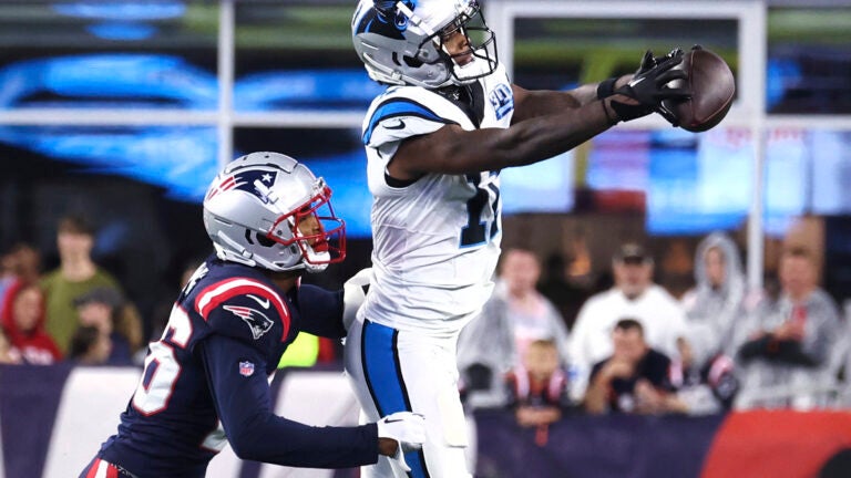 Carolina Panthers wide receiver Ihmir Smith-Marsette (11) grabs a pass against New England Patriots cornerback Shaun Wade, left, during the first half of a preseason NFL football game.