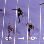 Quincy Hall, of the United States, lane eight, wins the men's 400-meter final at the 2024 Summer Olympics.