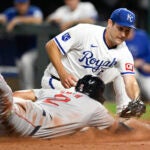Boston Red Sox's Dominic Smith (2) beats the tag by Kansas City Royals starting pitcher Seth Lugo to score during the sixth inning of a baseball game.
