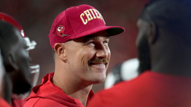 Chiefs tight end Travis Kelce smiles on the sidelines during an NFL preseason game against the Bears.
