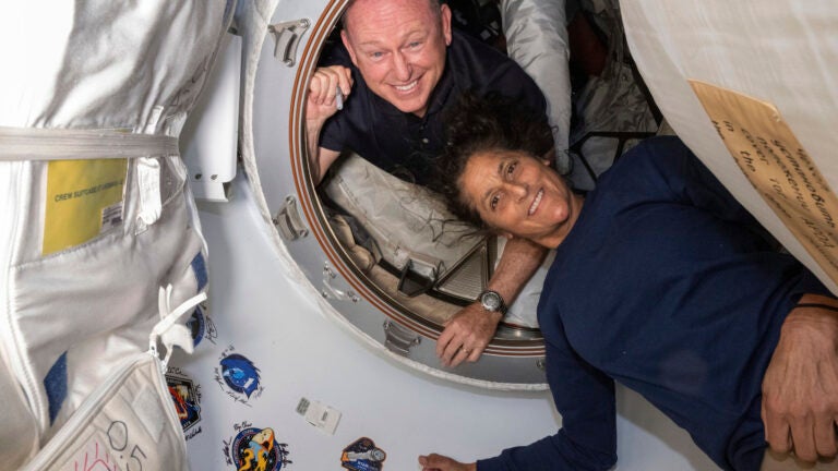 In this photo provided by NASA, Boeing Crew Flight Test astronauts Butch Wilmore, left, and Suni Williams pose for a portrait inside the vestibule between the forward port on the International Space Station's Harmony module and Boeing's Starliner spacecraft on June 13, 2024.