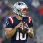 New England Patriots quarterback Drake Maye (10) looks to throw against the Carolina Panthers in the first half of a preseason game at Gillette Stadium.