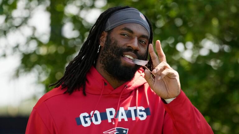 New England Patriots linebacker Matthew Judon walks onto the field during a joint NFL football practice with the Philadelphia Eagles, Tuesday, Aug. 13, 2024, in Foxborough, Mass.