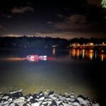 A pickup truck drifts several yards offshore in the Merrimack River after it drove into the water at the boat ramp near Bridge and Church streets on Sunday night.