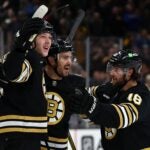 BOSTON, MASSACHUSETTS - FEBRUARY 29: Mason Lohrei #6 of the Boston Bruins celebrates with Kevin Shattenkirk #12 and Pavel Zacha #18 after scoring the game winning goal against the Vegas Golden Knights during the third period at TD Garden on February 29, 2024 in Boston, Massachusetts. The Bruins defeat the Knights 5-4.