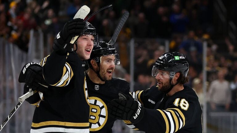 BOSTON, MASSACHUSETTS - FEBRUARY 29: Mason Lohrei #6 of the Boston Bruins celebrates with Kevin Shattenkirk #12 and Pavel Zacha #18 after scoring the game winning goal against the Vegas Golden Knights during the third period at TD Garden on February 29, 2024 in Boston, Massachusetts. The Bruins defeat the Knights 5-4.