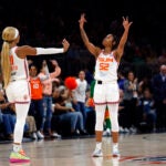 Connecticut Sun guard Tyasha Harris (52) reacts with guard DiJonai Carrington (21) after Harris hits a three-point basket to end the first half at TD Garden.