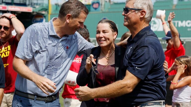 Boston Red Sox president and CEO Sam Kennedy, left, talks with Massachusetts Gov. Maura Healey, center, and John Frates, after taking the Ice Bucket Challenge during ceremonies on the fundraising event's 10th anniversary at Fenway Park, Thursday, Aug. 1, 2024, in Boston.