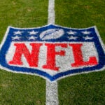 The NFL logo is displayed on the field at the Bank of American Stadium.