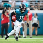 Jacksonville Jaguars wide receiver Parker Washington (11) returns a kickoff during the first half of a preseason NFL football game against the Kansas City Chiefs.
