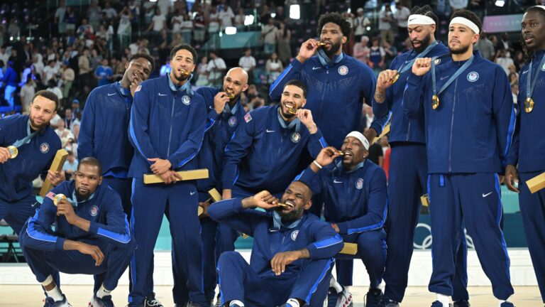 Gold medallists (From L) USA's #04 Stephen Curry, USA's #07 Kevin Durant, USA's #05 Anthony Edwards, USA's #09 Tyrese Haliburton, USA's #08 Derrick White, USA's #10 Jayson Tatum, USA's #06 LeBron James, USA's #11 Joel Embiid, USA's #13 Bam Adebayo, USA's #14 Anthony Davis, USA's #15 Devin Booker and USA's #12 Jrue Holiday pose on the podium after the men's Gold Medal basketball match between France and USA during the Paris 2024 Olympic Games at the Bercy Arena in Paris on August 10, 2024.