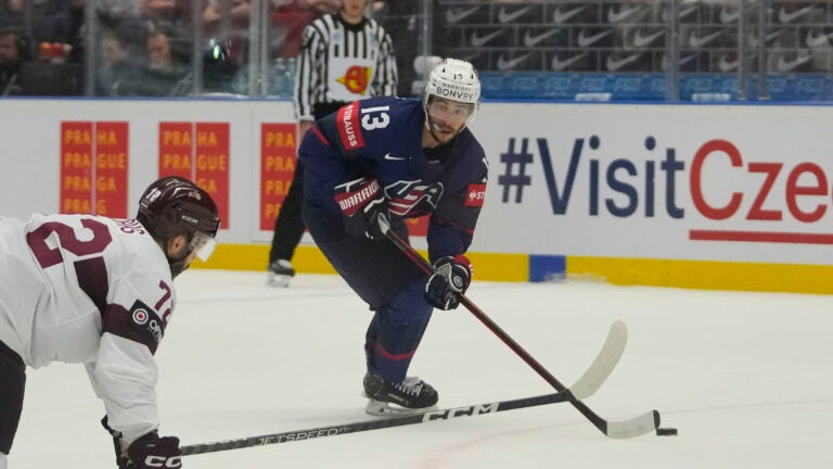 Johnny Gaudreau fights for the puck with Latvian Janis Jaks during a preliminary round game at the Ice Hockey World Championship in Ostrava, Czech Republic.