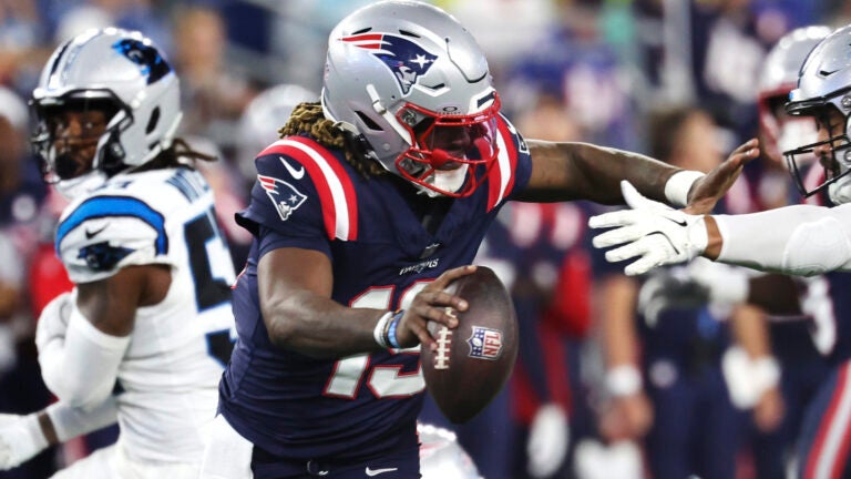 New England Patriots quarterback Joe Milton eludes a sack during the second half of a preseason NFL football game against the Carolina Panthers, Thursday, Aug. 8, 2024, in Foxborough, Mass.