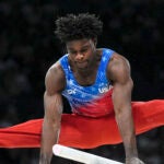 Frederick Richard performs on the parallel bars in Bercy Arena at the 2024 Paris Olympics.