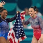 Simone Biles, left, celebrates with teammate Suni Lee, of the United States, after winning the gold and bronze medals respectively in the women's artistic gymnastics all-around finals in Bercy Arena at the 2024 Summer Olympics.