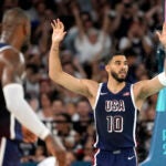 Jayson Tatum celebrates after dunking during a men's basketball game against Brazil at the 2024 Olympics.